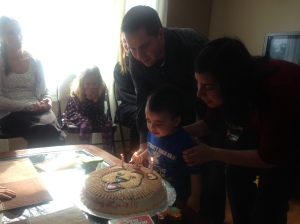 The birthday boy blowing out the candles. 
