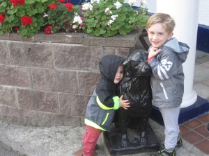 The boys giving their traditional morning hug to the "black dog" outside the "black dog pub"
